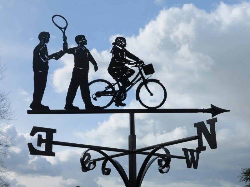 a weathervane with two children and a granny on a bicycle handmade by blacksmiths in Kent