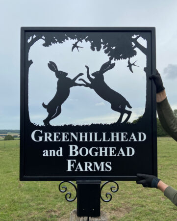 Boxing hares framed picture sign