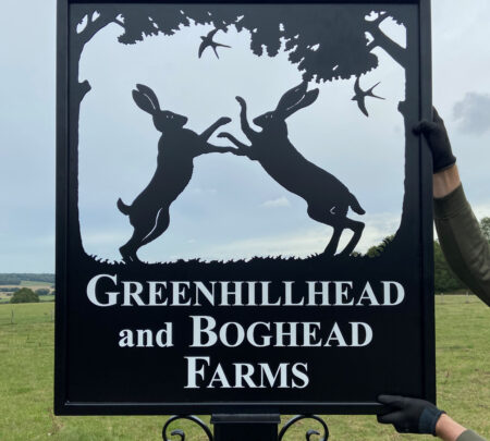 Boxing hares framed picture sign