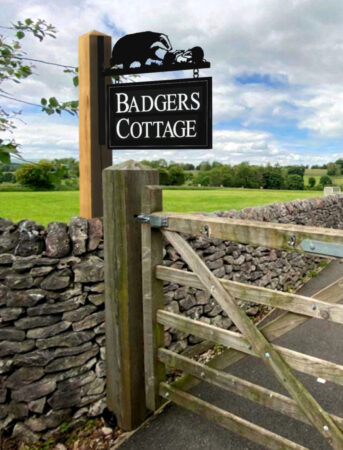 Badgers Cottage Sign Installed On Post Outside Farm
