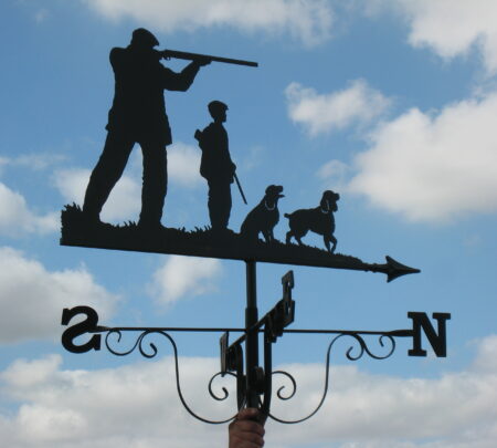 Grandfather, grandson and dogs shooting weathervane