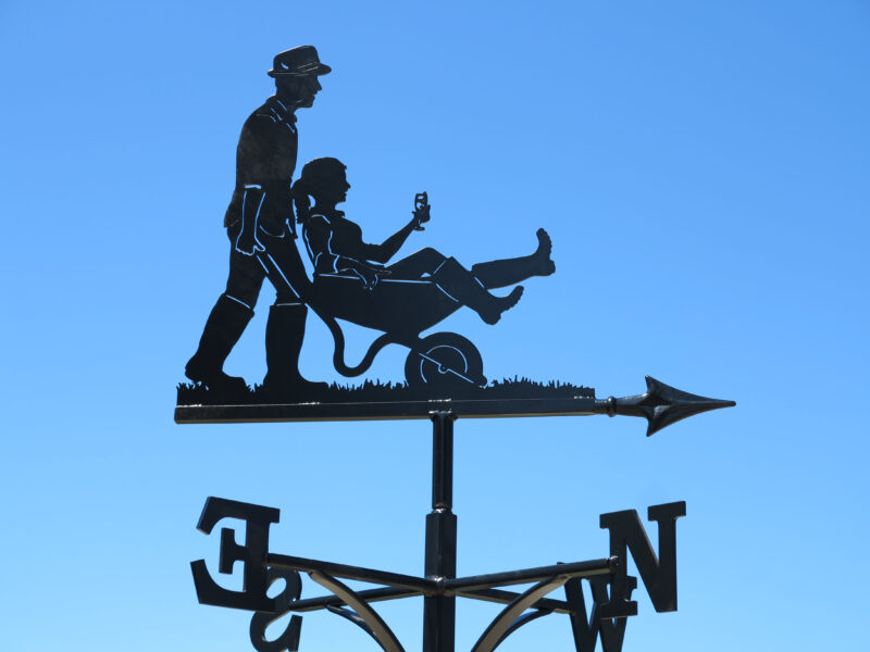Tiddly wife in wheelbarrow weathervane