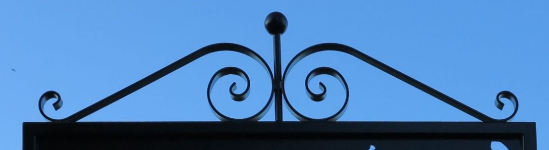 Scrolls Atop Sign Frame
