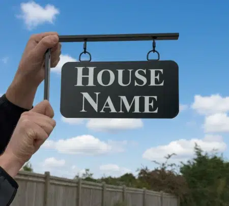 Small Hanging Metal House Name Sign - Rounded Corners Held Up Outside Workshop